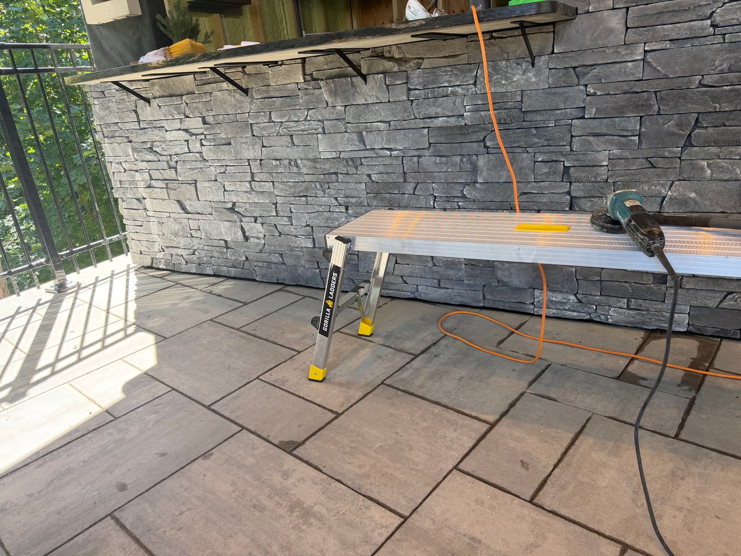 Finished gray stone wall beside a patio