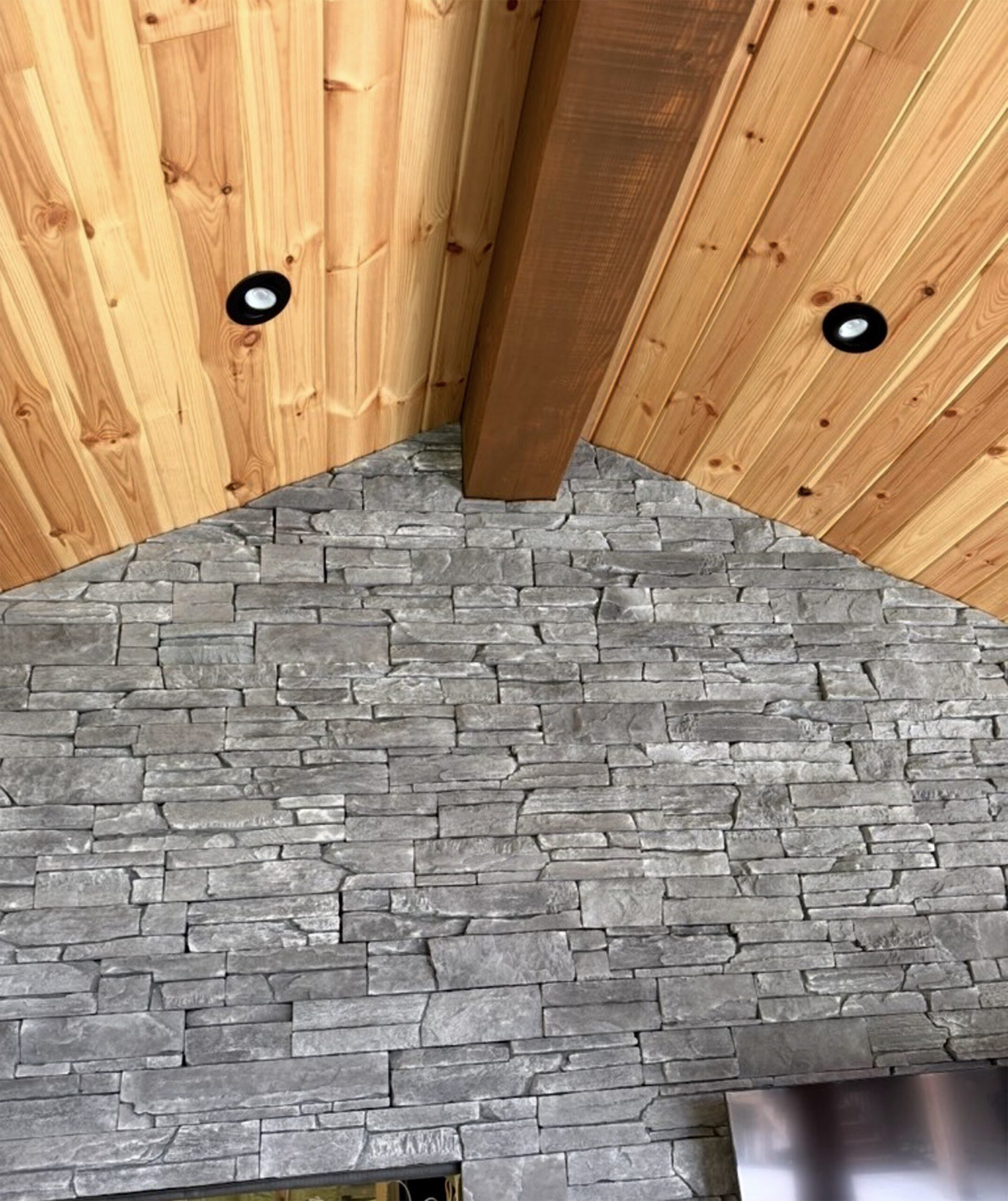 Sedistone stone veneer gable beneath a wood ceiling